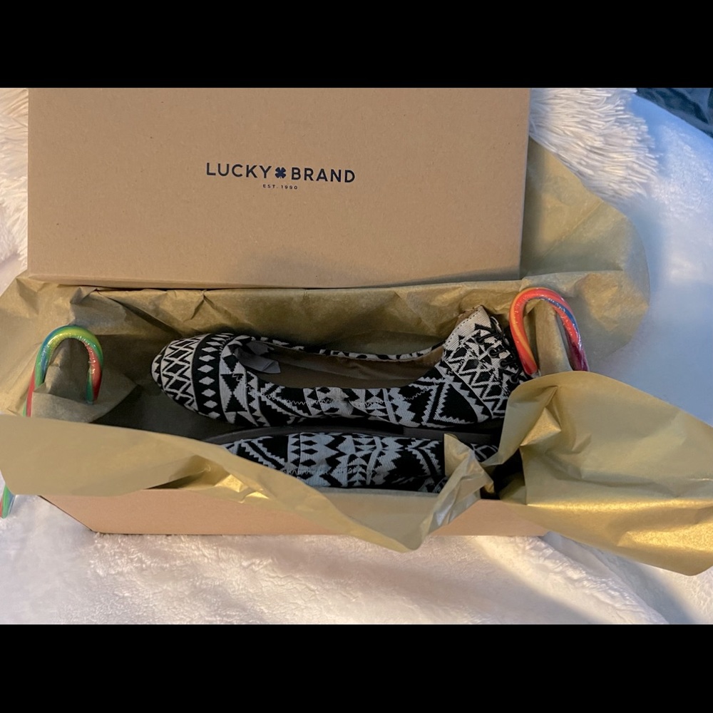 Size 7.5 black and white lucky shoes.